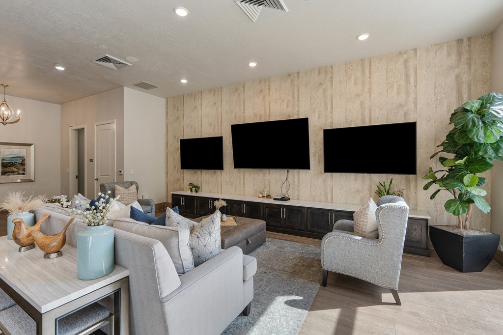 a living room with couches and chairs and televisions on the wall at 200 City View, Provo, UT, 84601