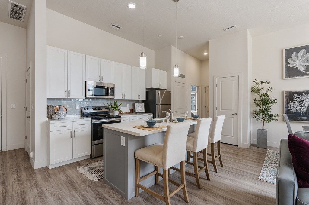 an open kitchen and dining area with a table and chairs at 200 City View, Provo, UT