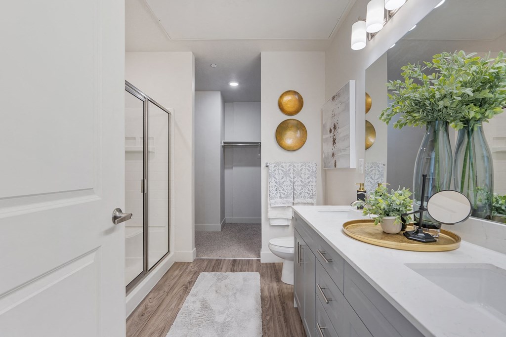 a bathroom with a shower and a sink and a mirror at 200 City View, Provo