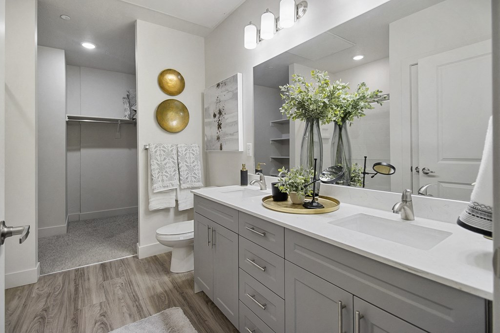 a bathroom with white cabinets and a white toilet at 200 City View, Provo, Utah