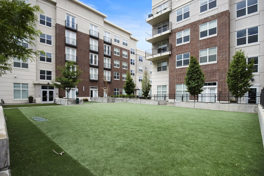 a large grassy area with trees in front of an apartment building at 200 City View, Provo, UT