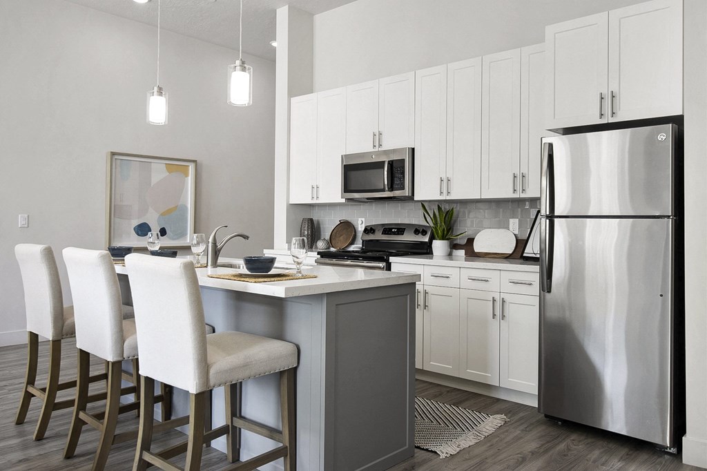 a kitchen with white cabinets and stainless steel appliances at 200 City View, Provo, Utah
