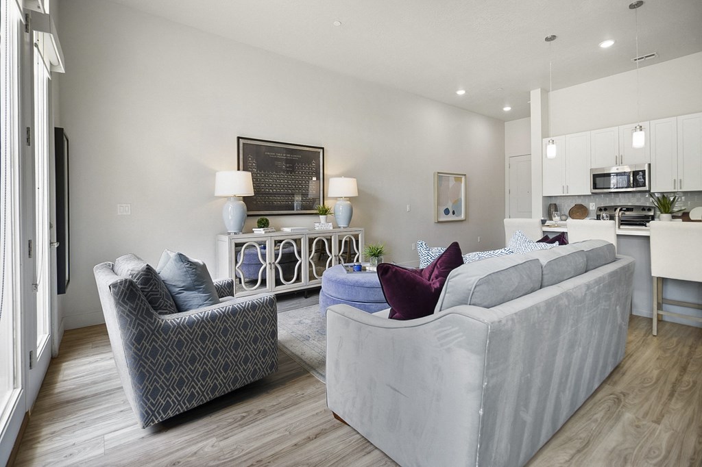 a living room with two couches and two chairs and a kitchen in the background at 200 City View, Provo, 84601