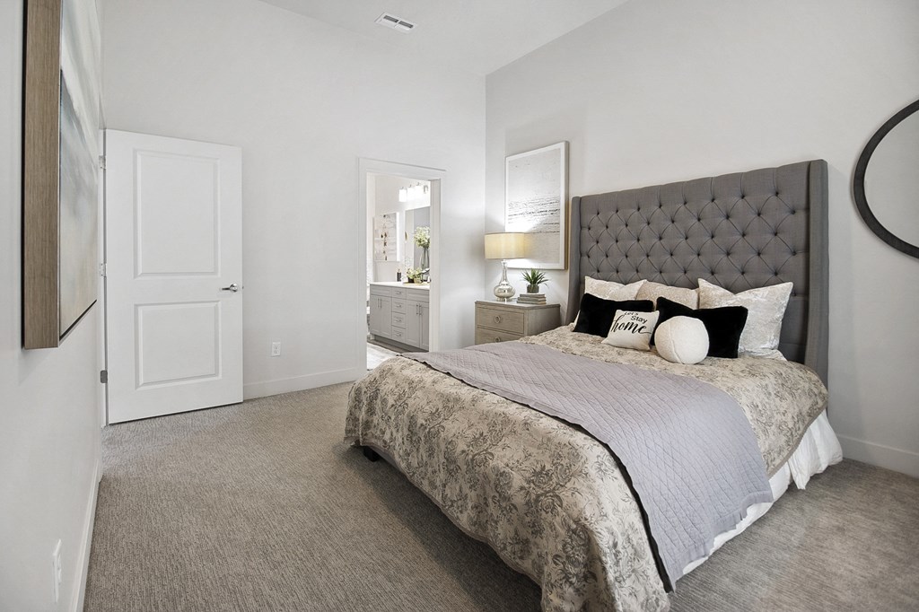 a bedroom with a bed and a door to a bathroom at 200 City View, Utah