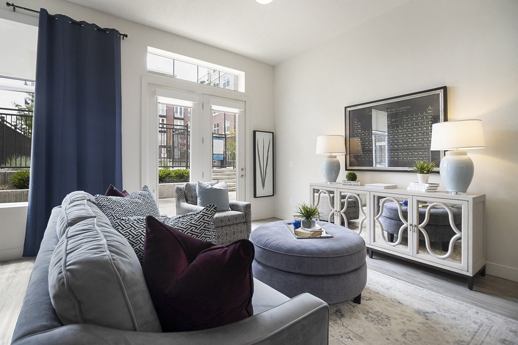 a living room with a gray couch and a gray ottoman at 200 City View, Provo