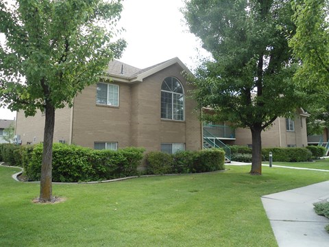 A building with a green lawn in front.