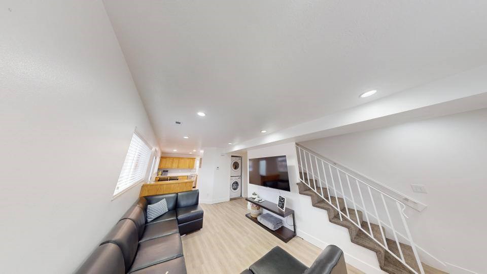 A living room with a staircase leading to the upper floor.