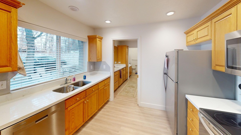 A kitchen with wooden cabinets and stainless steel appliances.