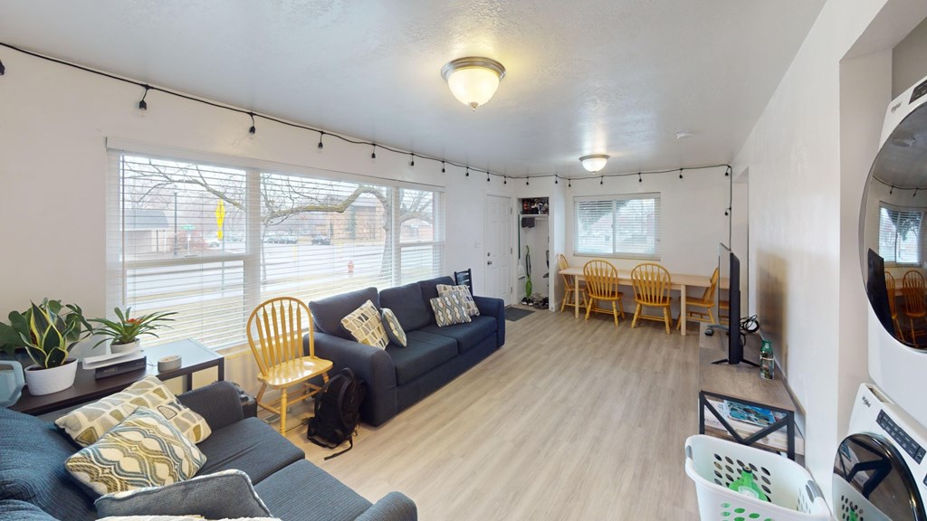 A living room with a blue couch and a yellow chair.