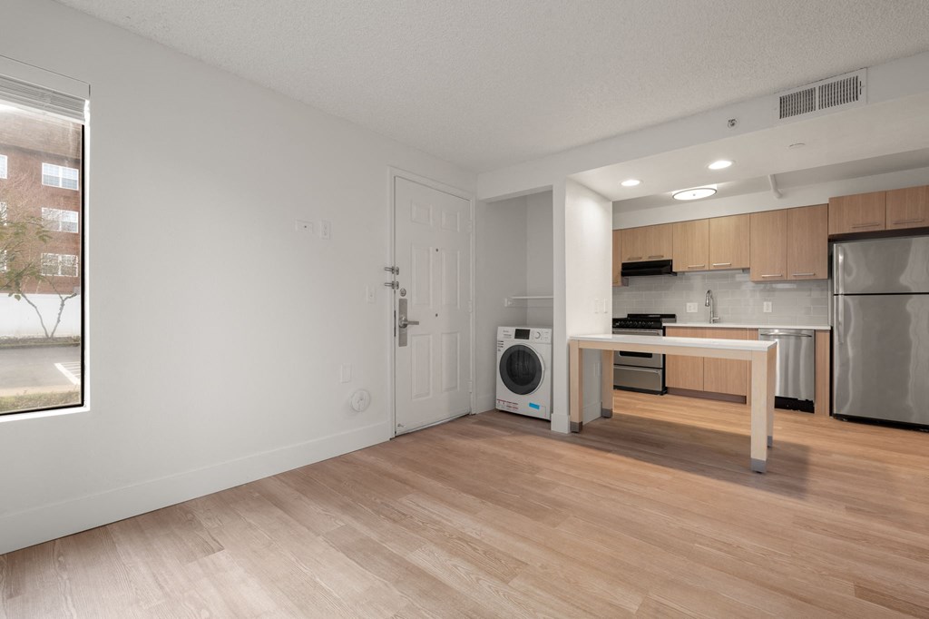 A modern kitchen with wooden floors and stainless steel appliances at AVIA Lofts on Parkway Apartments, Vancouver, Washington