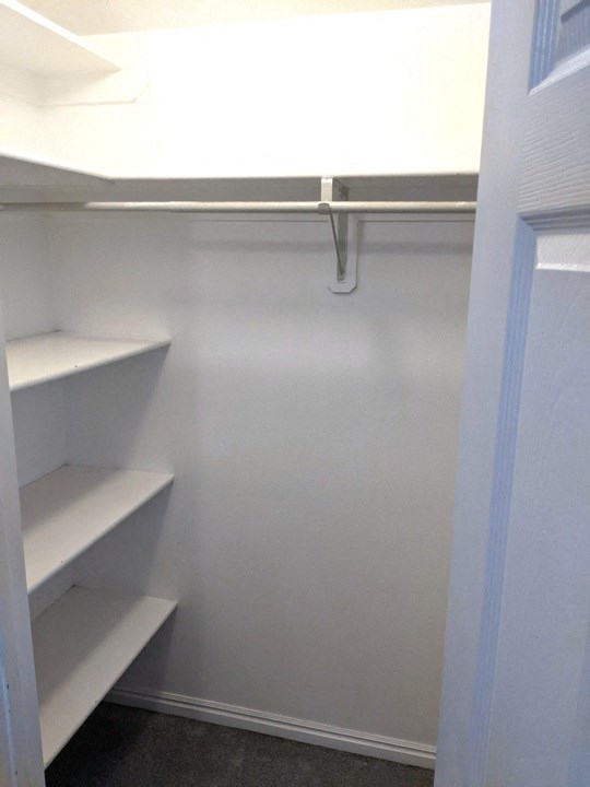 Empty white shelves in a room.