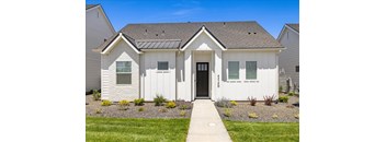A white house with a black door and windows.