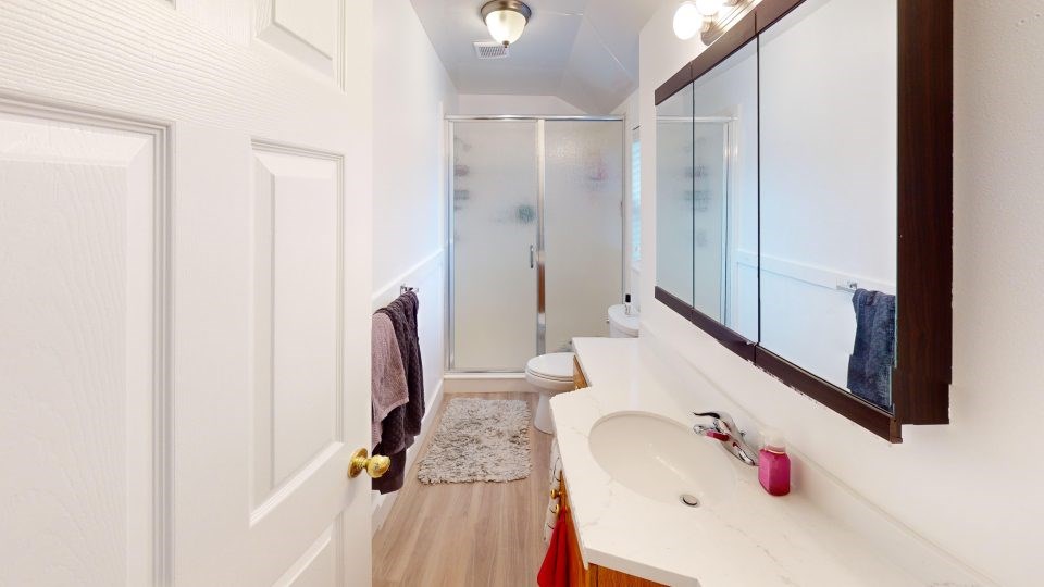 A bathroom with a white sink and a mirror.