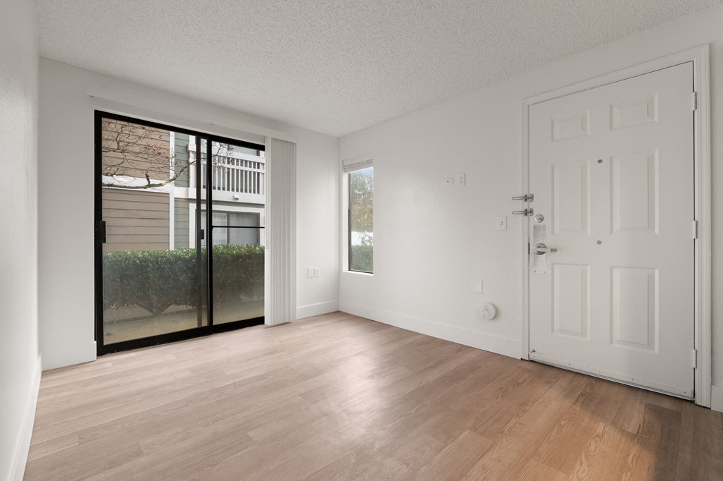 A room with a white door and a sliding glass door leading to a balcony at AVIA Lofts on Parkway Apartments, Vancouver, 98662