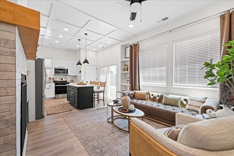A modern living room with a brown sofa and a wooden coffee table.