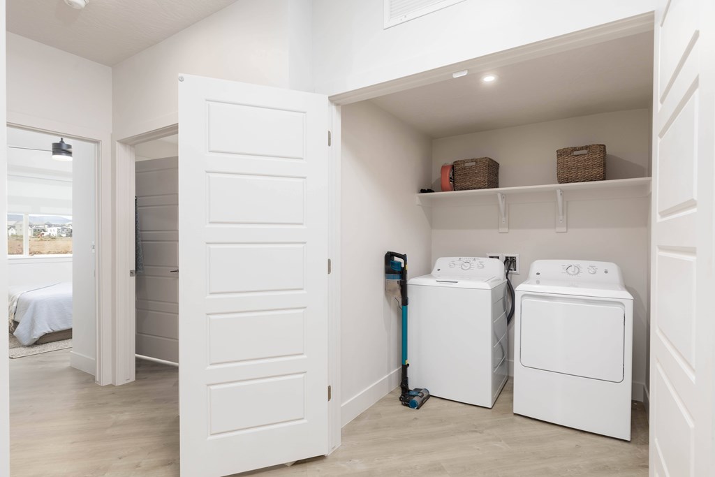 A white laundry room with a washer and dryer.