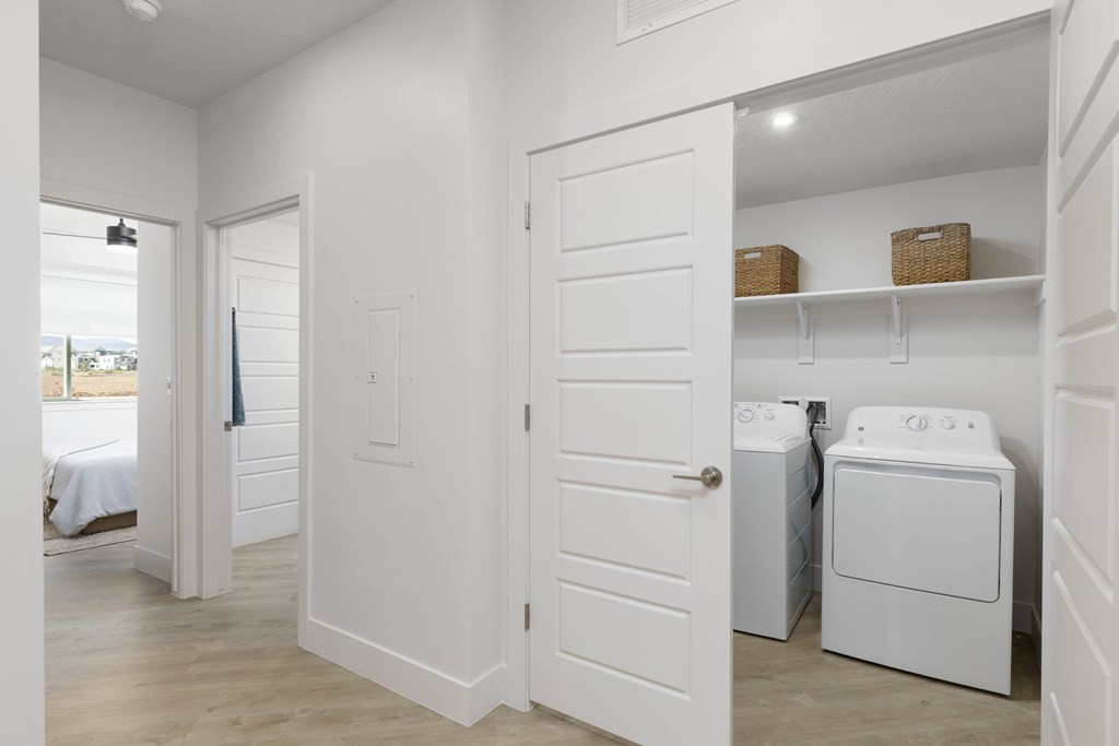A white laundry room with a washer and dryer.
