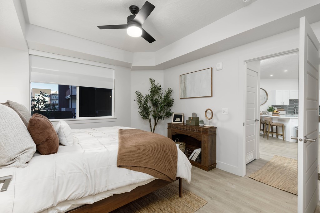 A bedroom with a large bed and a ceiling fan. at The Vue At Desert Color, St. George, Utah