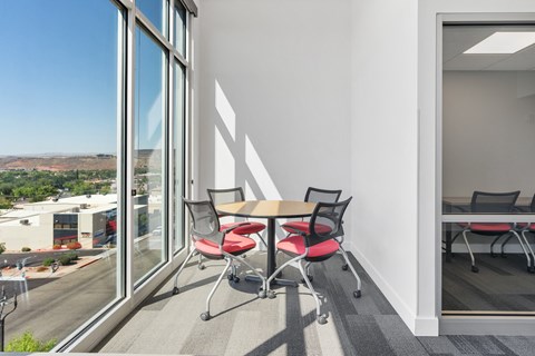 a conference room with a table and chairs and a large window at 605 Place Student Housing & Co-Living, St George, UT