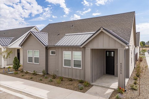 A grey house with a black door and windows. at Alante Homes at Spring Run, Caldwell, Idaho