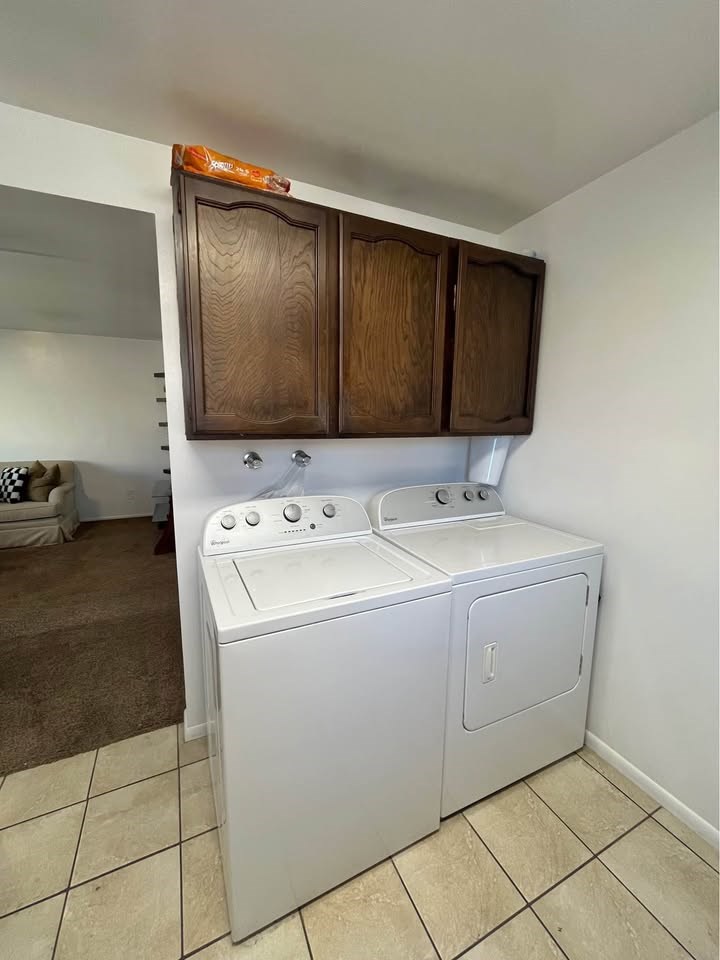 A white washer and dryer in a laundry room.