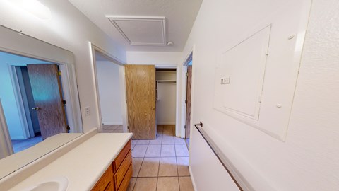 A bathroom with a sink, toilet and a window.