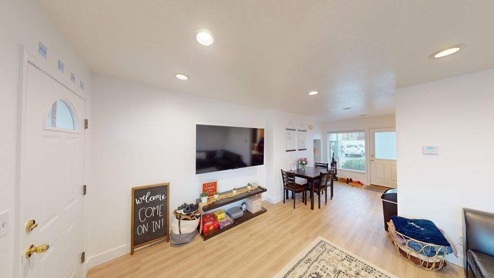 A living room with a sign that says "Welcome Come On In!".