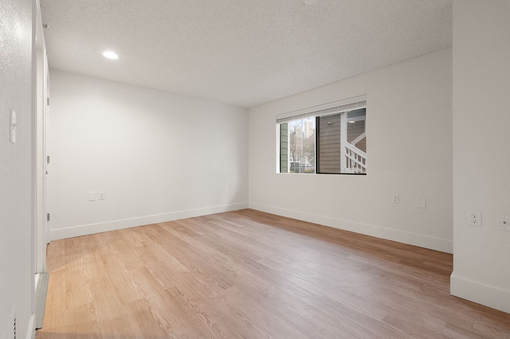 Empty room with wooden floor and a window at AVIA Lofts on Parkway Apartments, Washington