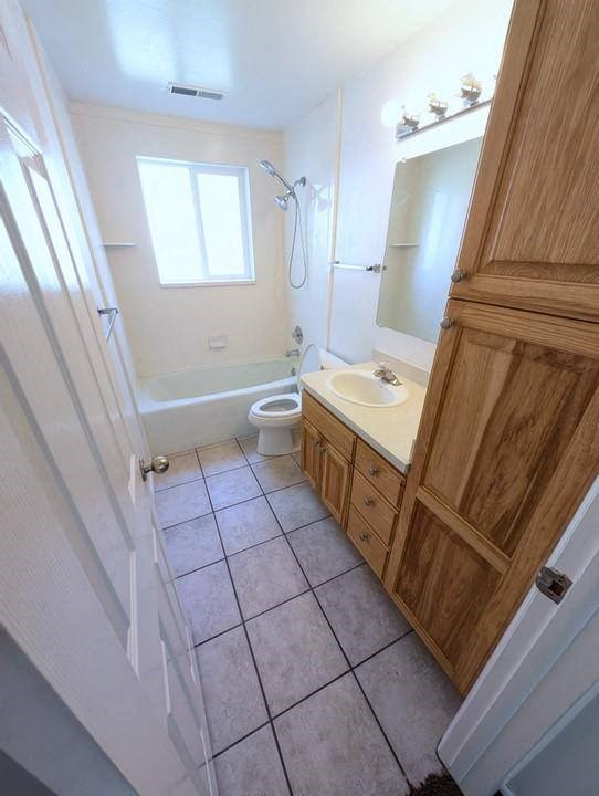 A bathroom with a toilet, sink, and mirror.