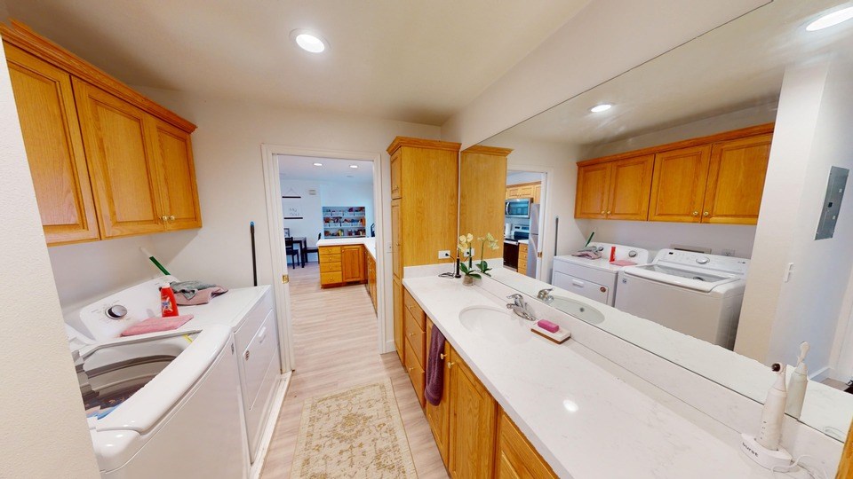 A kitchen with wooden cabinets and white countertops.