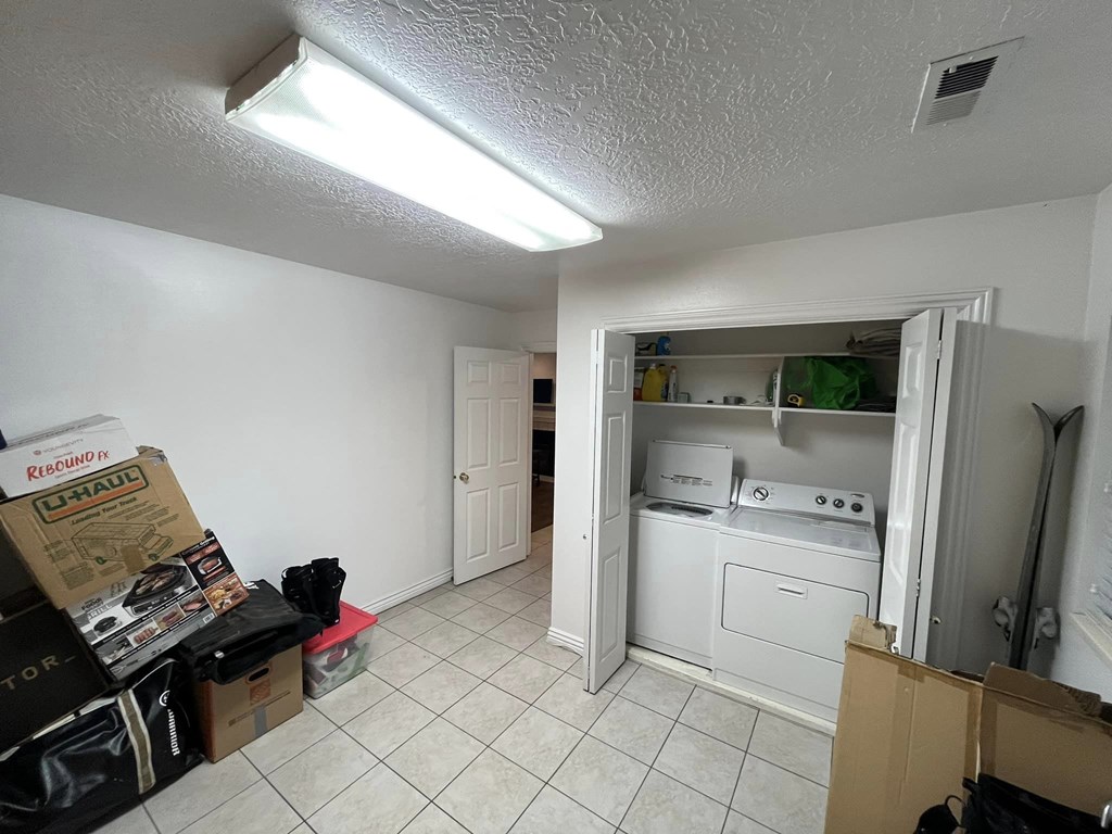 A room with a washer and dryer in it.