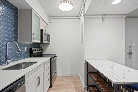 kitchen with sink and stove and counter top at AVIA Lofts on Liberty Ridge Apartments, Jacksonville