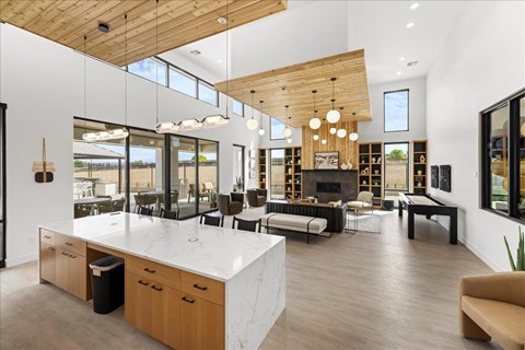 A modern kitchen with a large island and wooden ceiling. at Alante Homes at Spring Run, Caldwell, Idaho