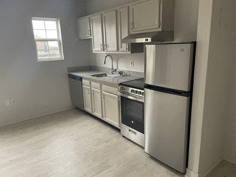 a kitchen with a stove and a refrigerator