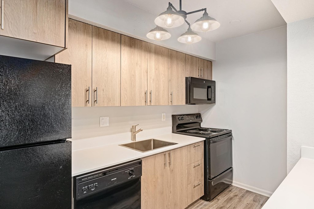 a kitchen with black appliances and wooden cabinets