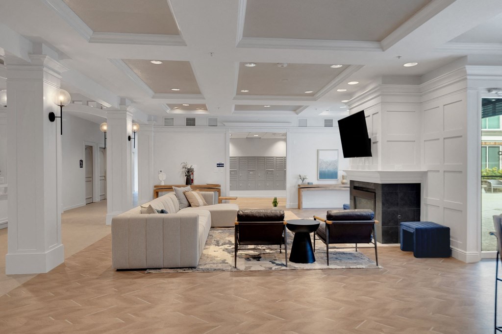 a living room with a couch and chairs and a fireplace