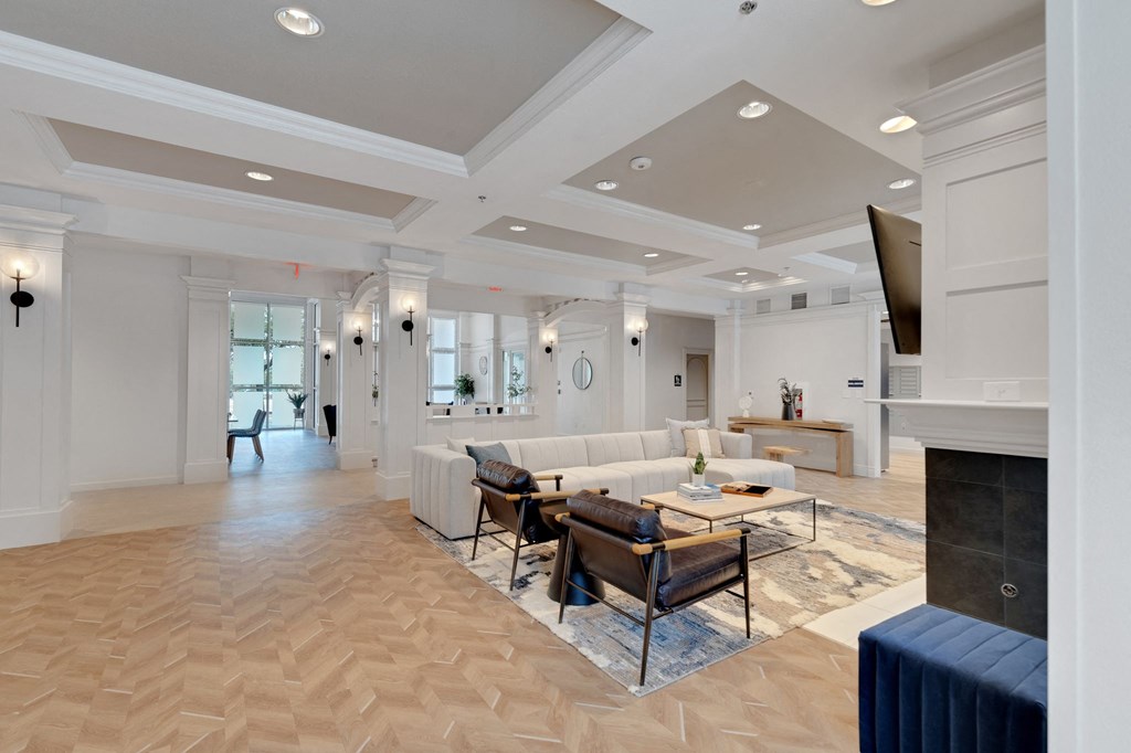 a living room with a fireplace and a table and chairs