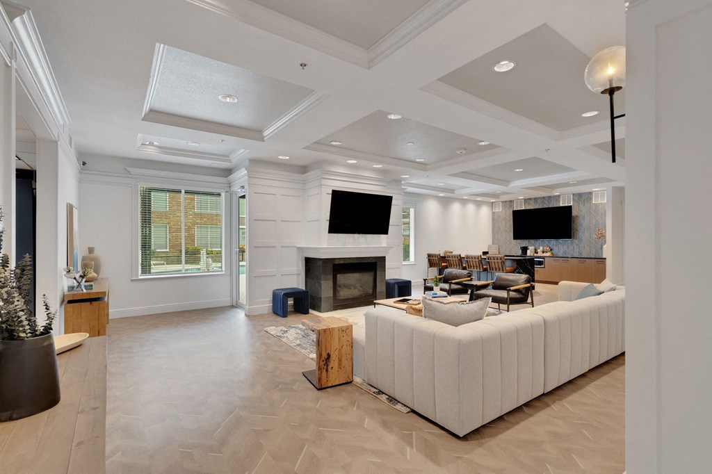 the living room has a fireplace and a large white couch