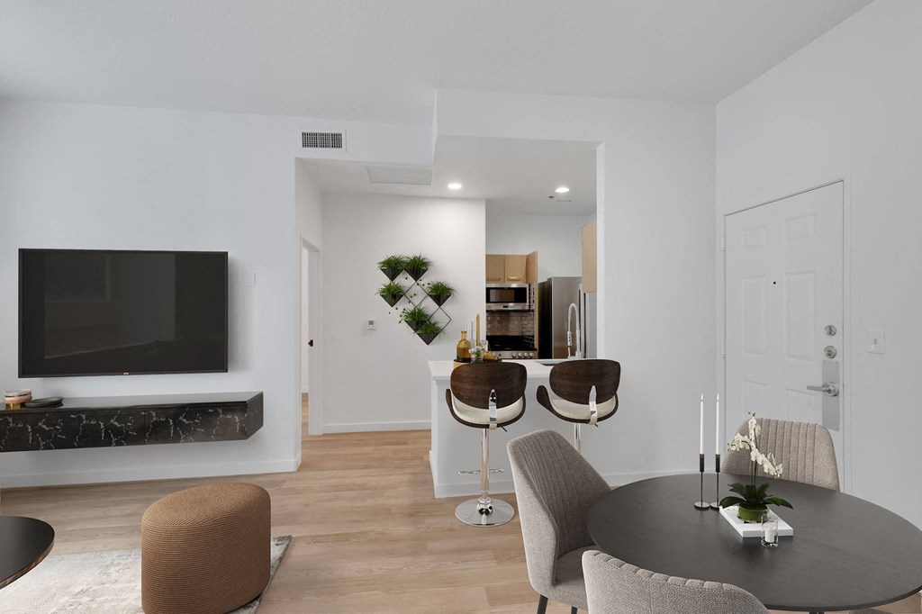 a living room with a table and chairs and a television