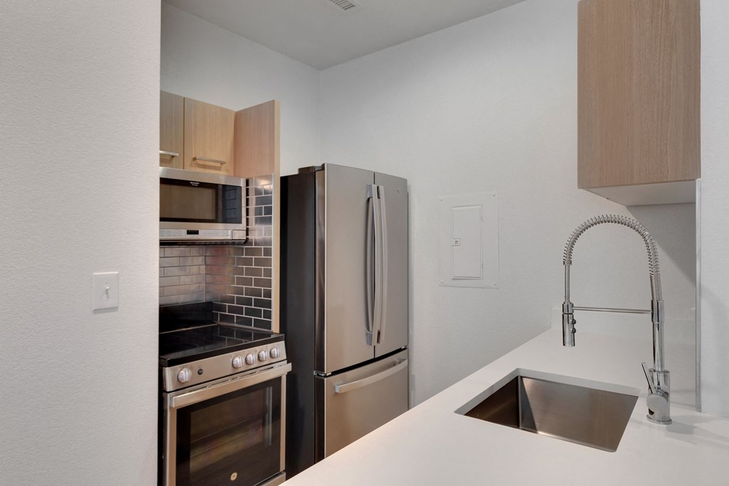 a kitchen with stainless steel appliances and a sink