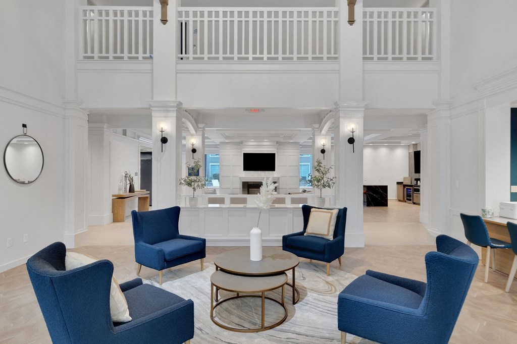 a living room with blue chairs and a coffee table