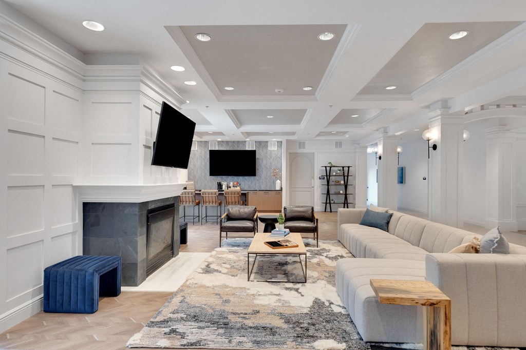 a living room with a couch and a table and a fireplace