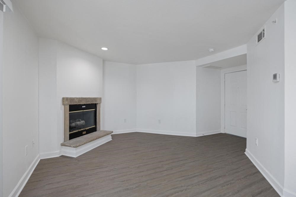 a living room with a fireplace and white walls