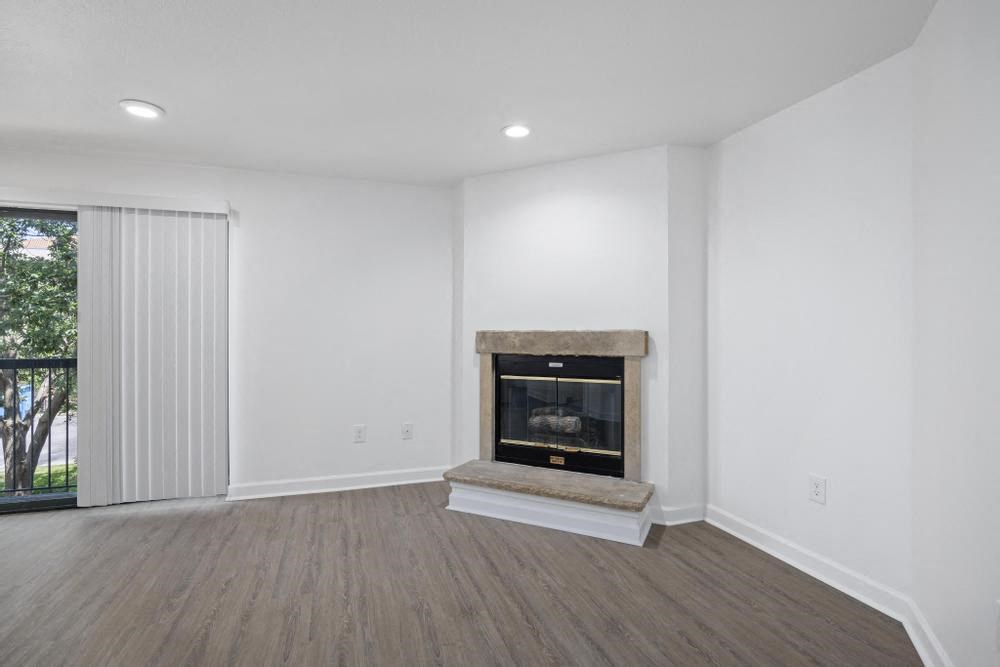 a living room with a fireplace and a window
