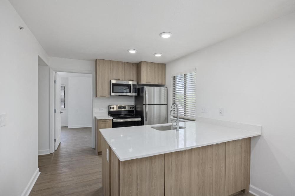 a kitchen with a large white counter top