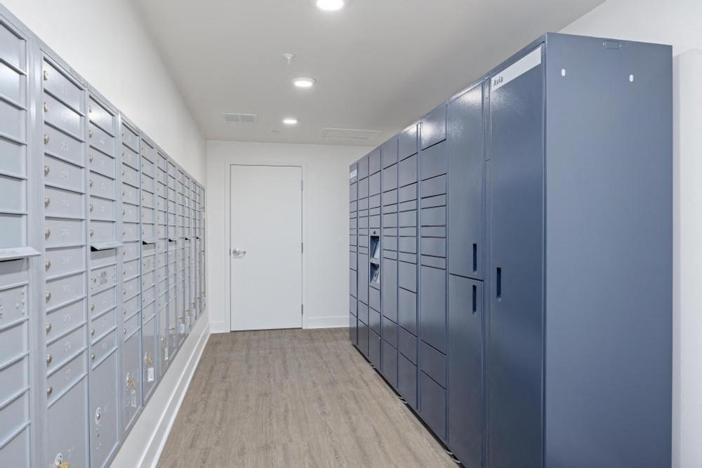 a row of lockers in a hallway with a door at the end