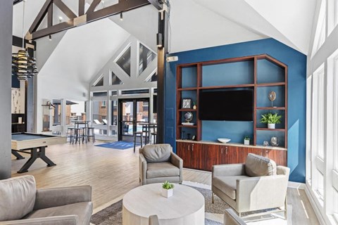 a living room with a blue wall and a table and chairs