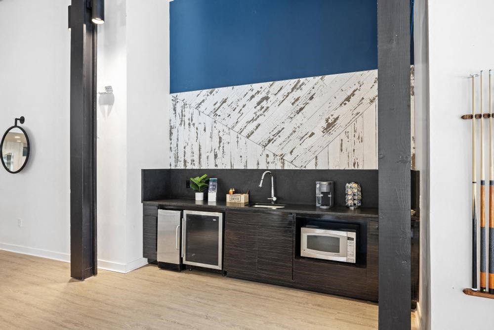 a kitchen with a sink and two microwaves