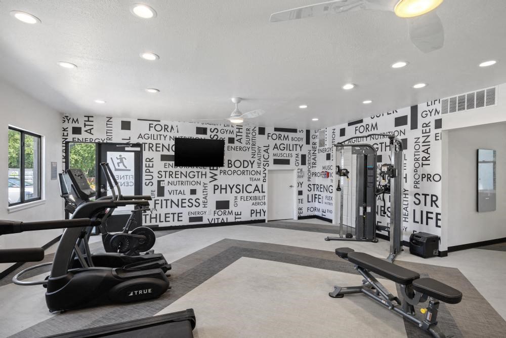 a gym with a wall covered in words