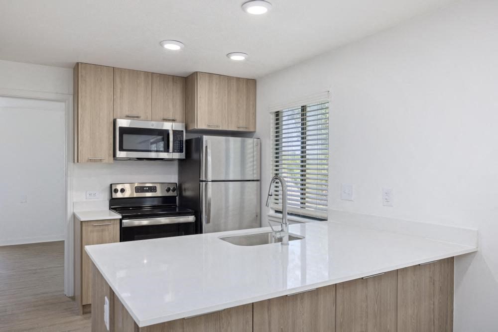 a kitchen with a large white counter top